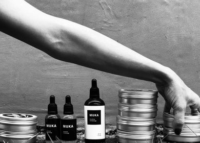 Hand arranging skincare jars at Muka Concepts Pererenan, Bali, Bali, ID. Showcasing natural beauty products.