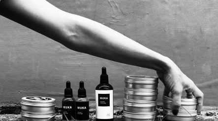 Hand arranging skincare jars at Muka Concepts Pererenan, Bali, Bali, ID. Showcasing natural beauty products.