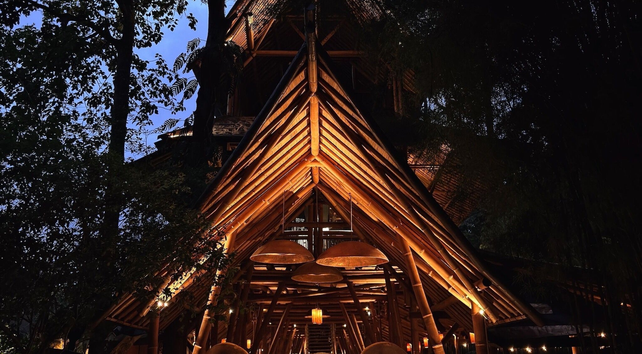 Muka Concepts Bambu Indah, bamboo architecture beautifully lit at night, Bali, Bali, ID.