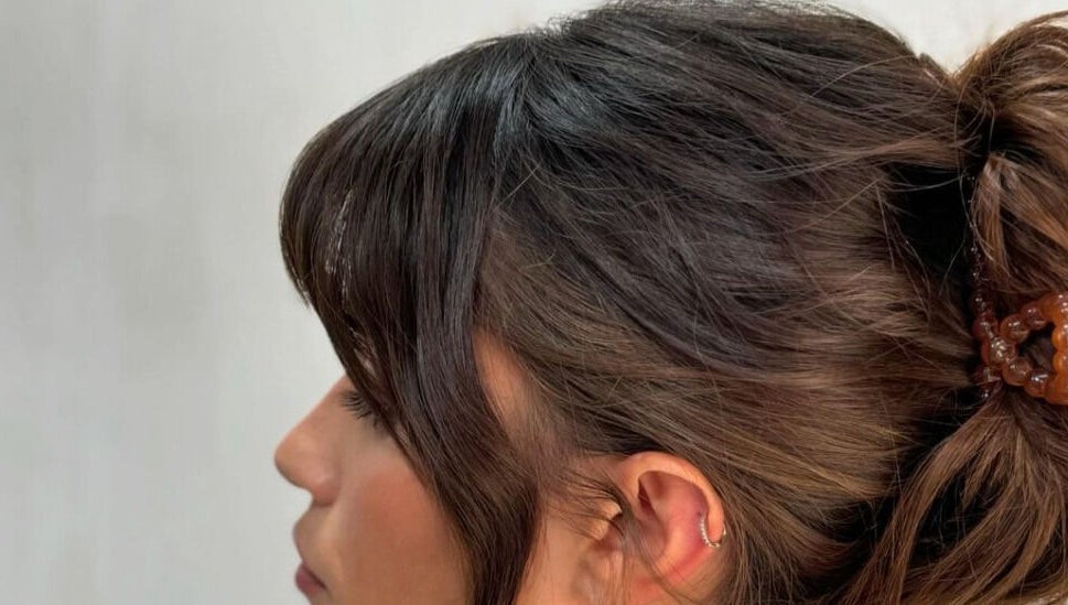 Side profile of a woman with a stylish updo at Studio Phoebe, Darsham, England, GB.