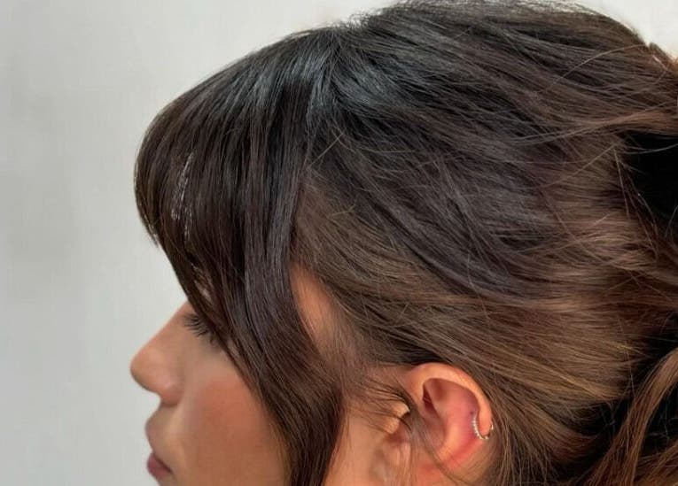 Side profile of a woman with a stylish updo at Studio Phoebe, Darsham, England, GB.