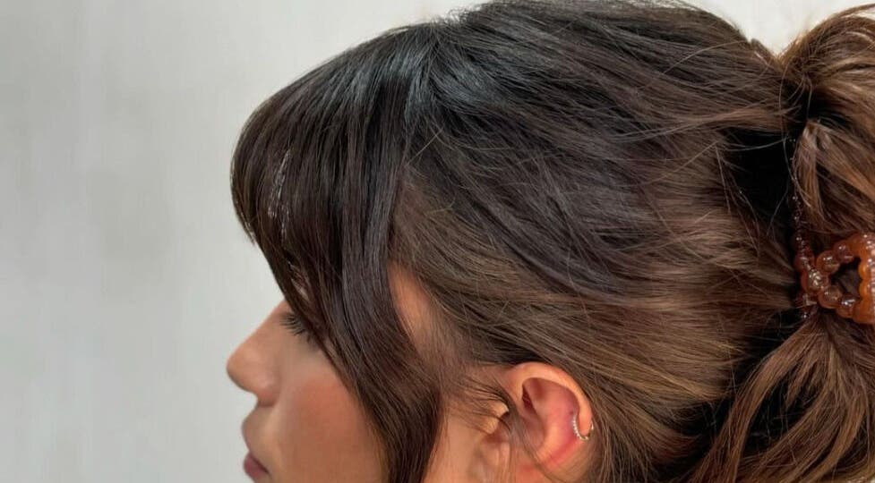 Side profile of a woman with a stylish updo at Studio Phoebe, Darsham, England, GB.