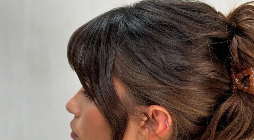 Side profile of a woman with a stylish updo at Studio Phoebe, Darsham, England, GB.