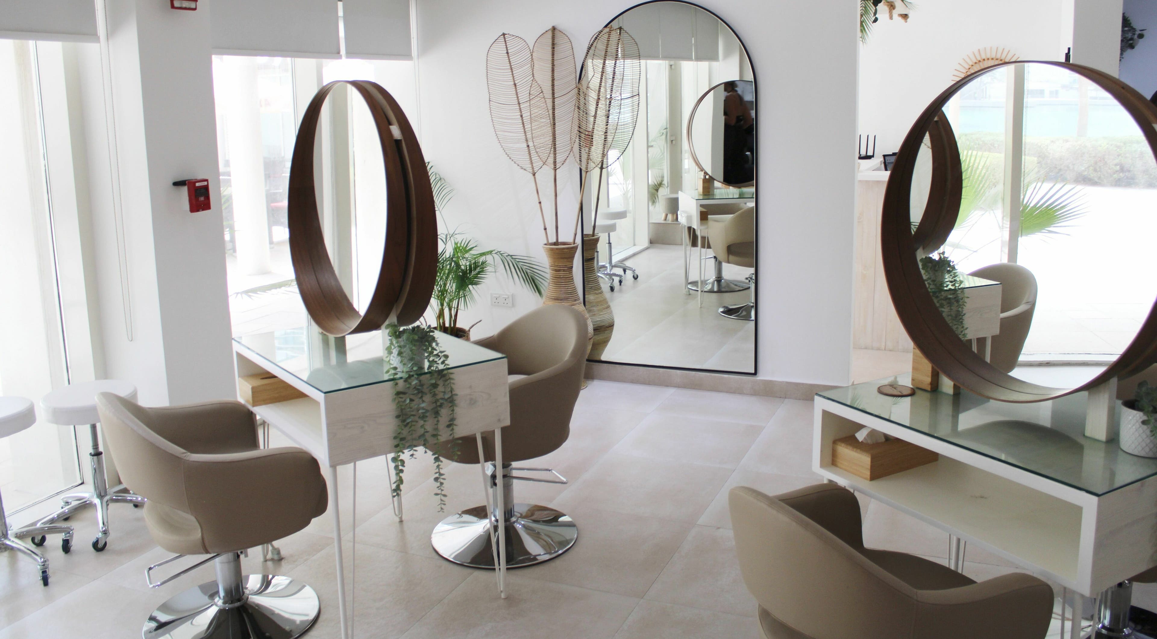 Chic interior of Willow Lane Hair and Beauty in Dubai, AE, featuring modern salon chairs and stylish mirrors.