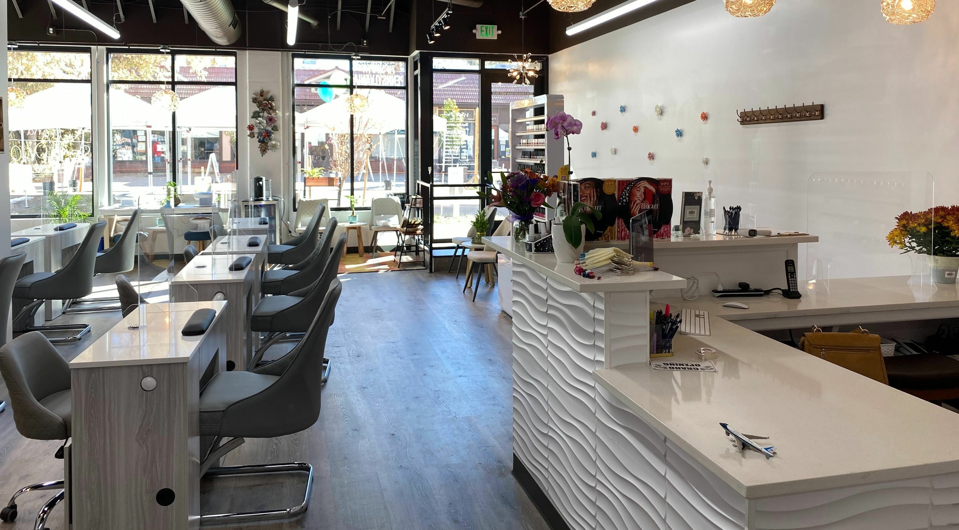 Bright, modern interior of My Friends Nail Spa in Denver, Colorado, US, showcasing sleek nail stations.