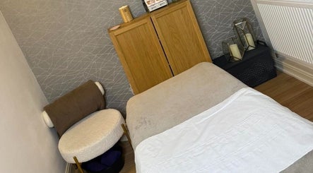 Cozy therapy room at Blush Beauty Suite, Yeadon, England, GB, featuring a comfortable treatment bed and decor.