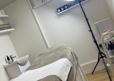 Tranquil treatment room at Blush Beauty Suite, Yeadon, England, GB, featuring massage bed and skincare products.