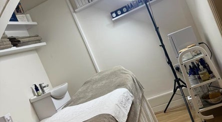 Tranquil treatment room at Blush Beauty Suite, Yeadon, England, GB, featuring massage bed and skincare products.