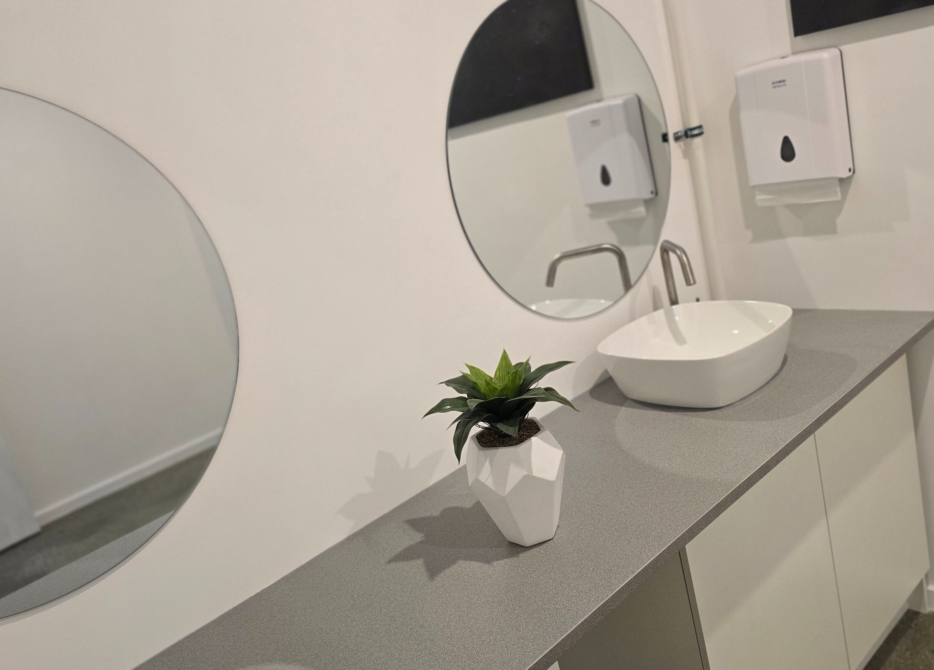 Modern bathroom basin with mirror at Elite Business Studios Pty Ltd, Joondalup, Western Australia, AU.
