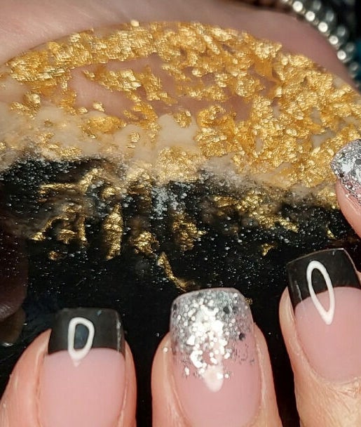 Elegant black and silver nail art at Melissa's Nails, Centurion, Gauteng, ZA with a luxurious, textured coaster.