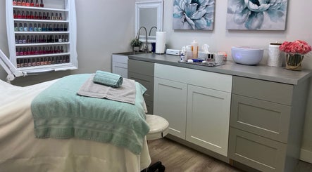 Elegant treatment room at Posh & Passion Esthetics, Trail, British Columbia, CA with calming decor and nail polish display.