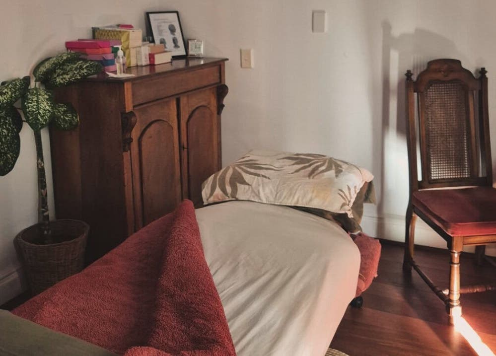 Cozy massage room at Aurora Bodywork Mobile Massage, Perth, Western Australia, AU. Elegant chair and lush decor.