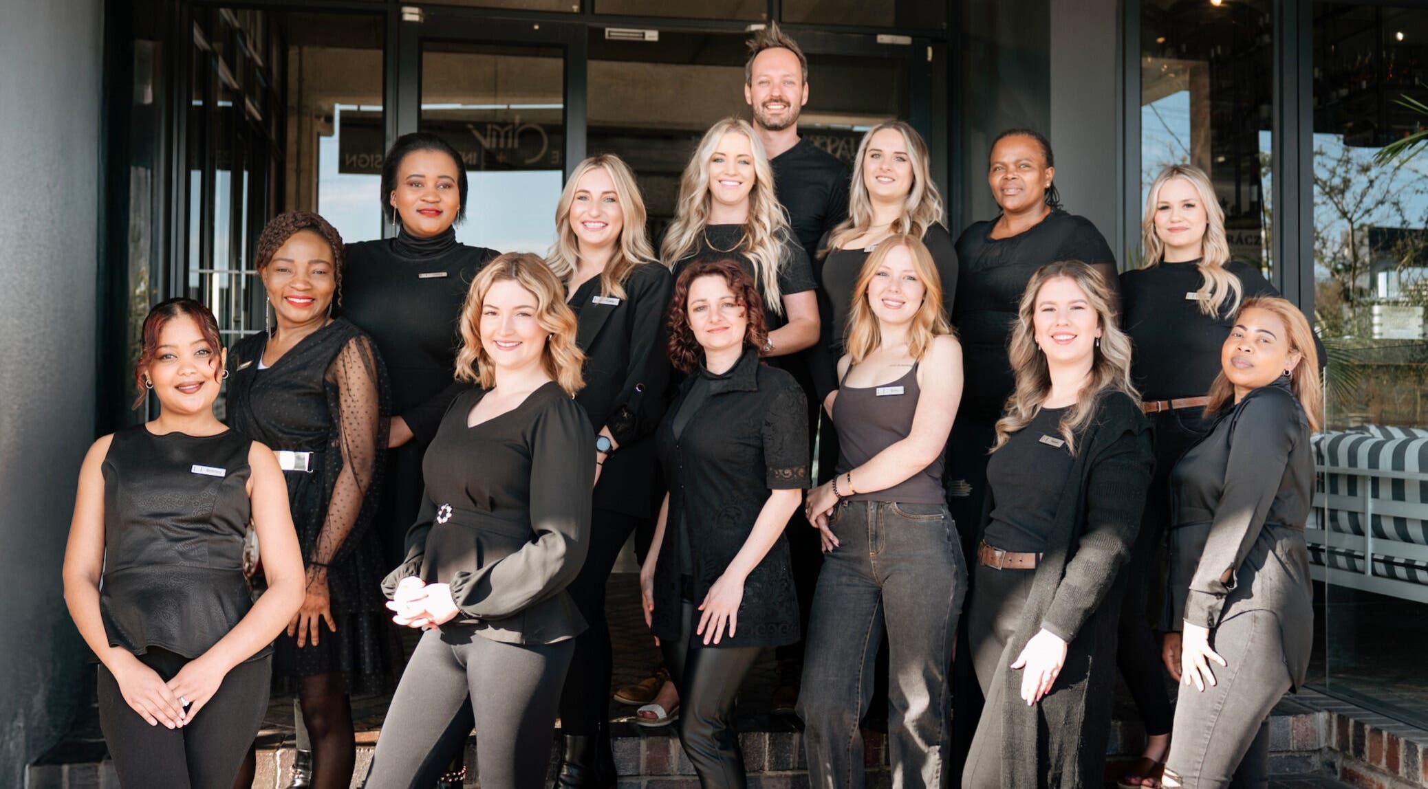 Elite Hair & Beauty team smiling outside the venue in Gqeberha, Eastern Cape, ZA.