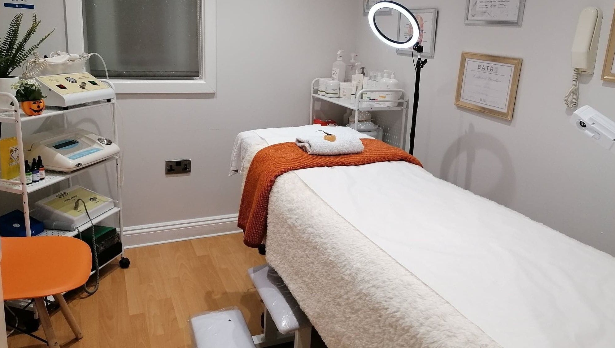 Cozy treatment room at Lamis Aesthetics, Timperley, England, GB, featuring a massage table and soothing decor.