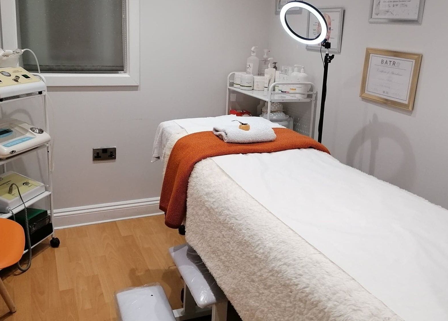 Cozy treatment room at Lamis Aesthetics, Timperley, England, GB, featuring a massage table and soothing decor.