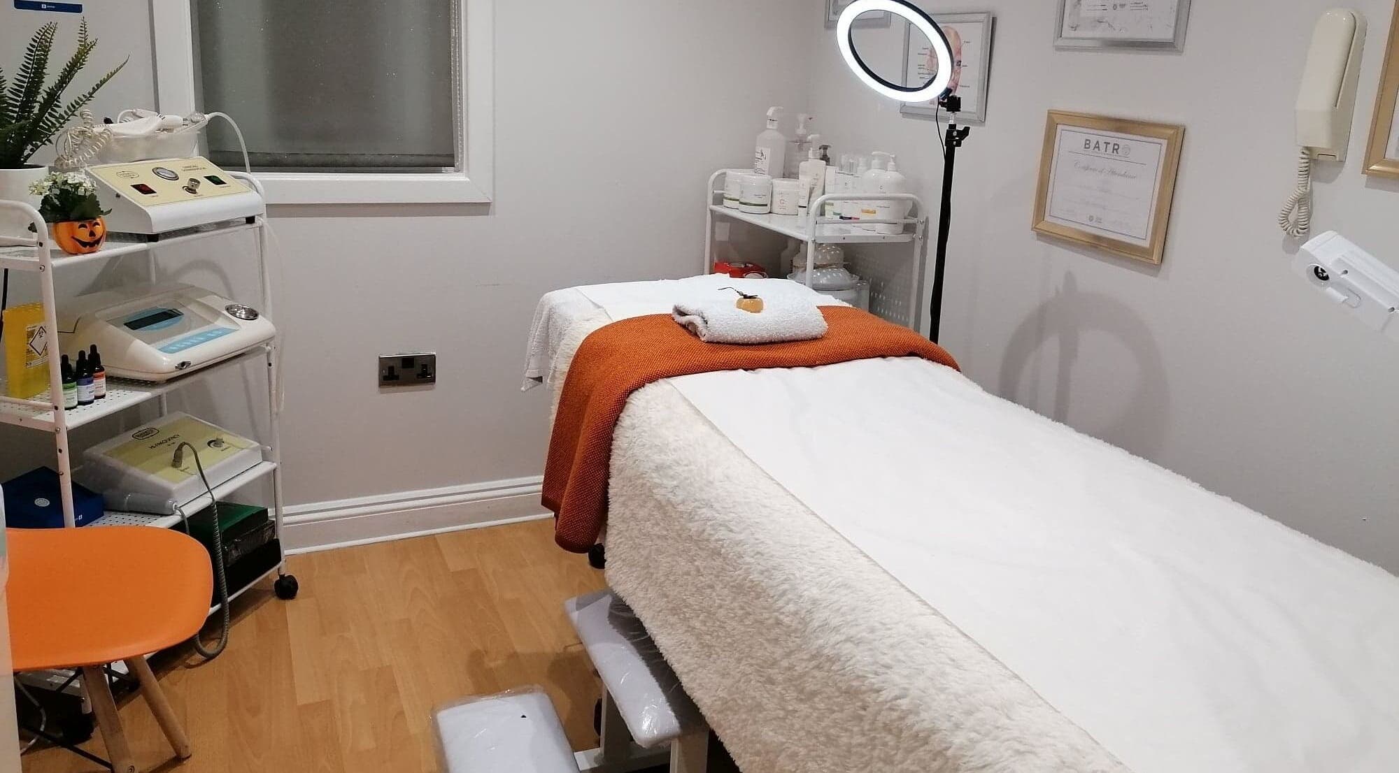 Cozy treatment room at Lamis Aesthetics, Timperley, England, GB, featuring a massage table and soothing decor.