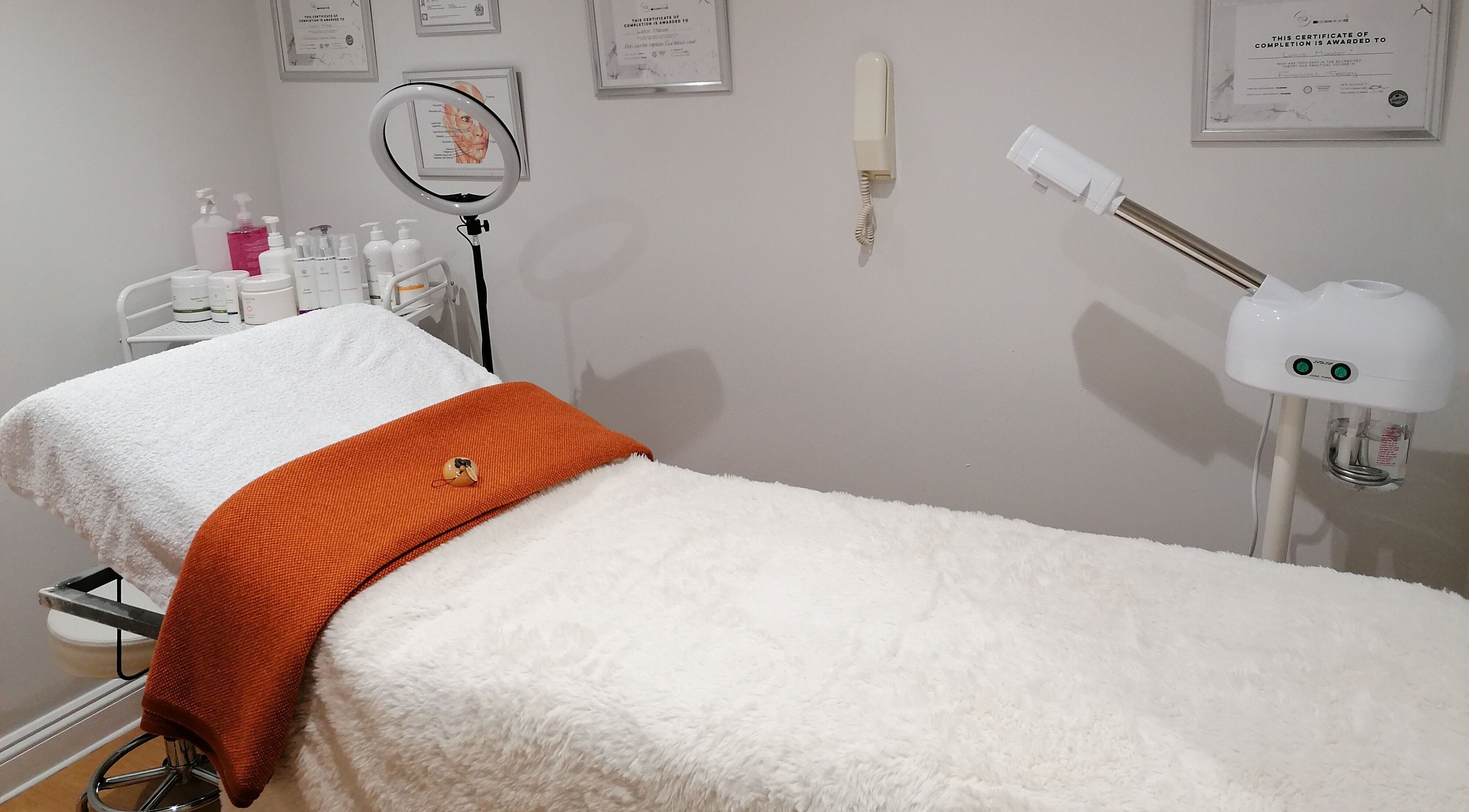 Relaxing spa treatment room at Lamis Aesthetics in Timperley, England, GB with plush bed and soothing décor.