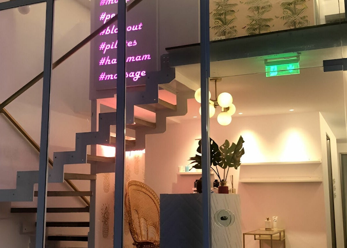 Staircase view at Oh My Spa in Argostoli, GR, showcasing stylish decor and neon lighting.