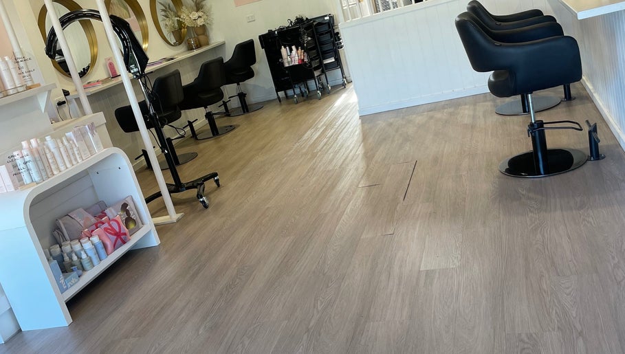 Stylish interior of Tina Choumar hairdresser in Fulham, South Australia, AU with salon chairs and products.