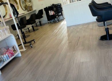 Stylish interior of Tina Choumar hairdresser in Fulham, South Australia, AU with salon chairs and products.
