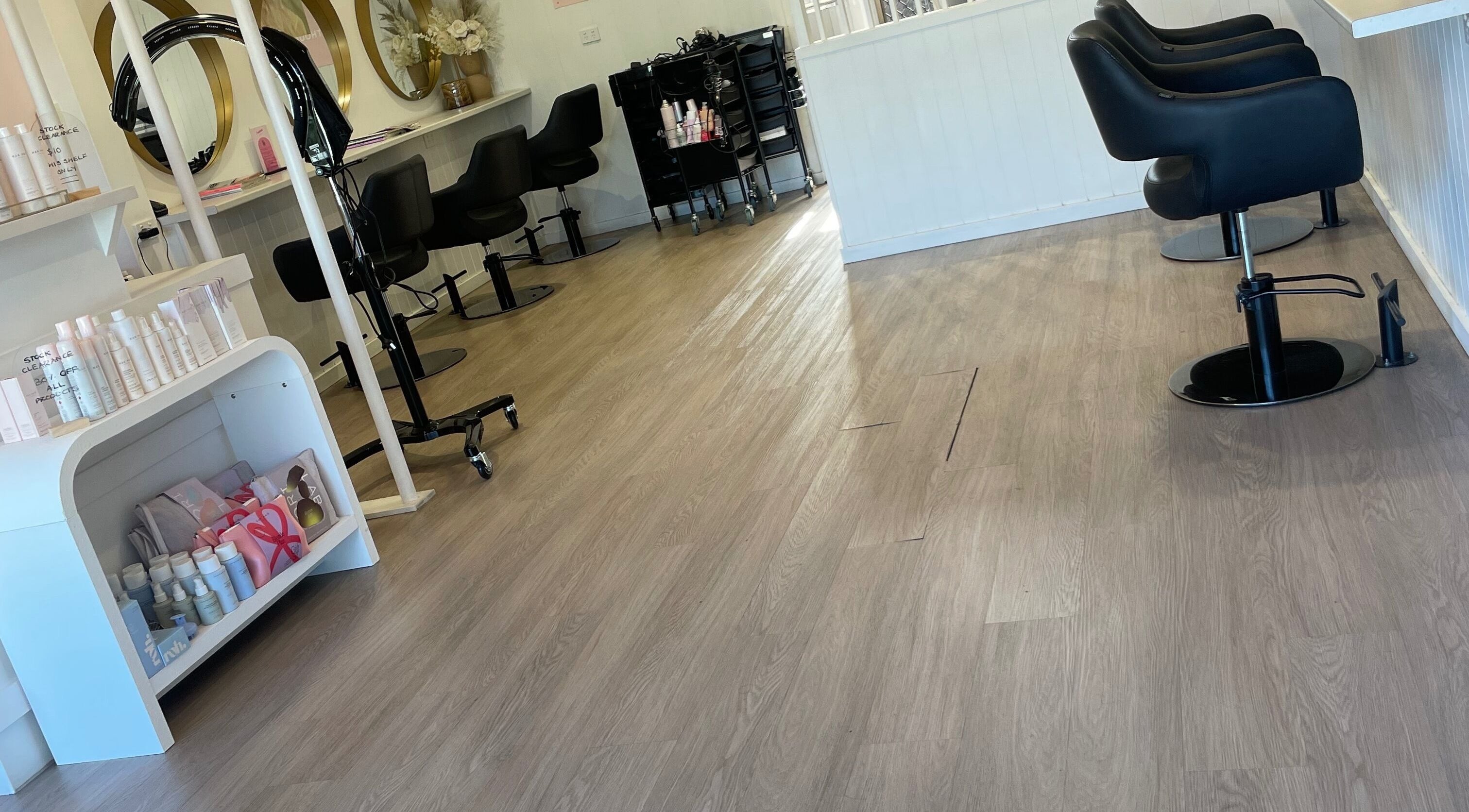 Stylish interior of Tina Choumar hairdresser in Fulham, South Australia, AU with salon chairs and products.