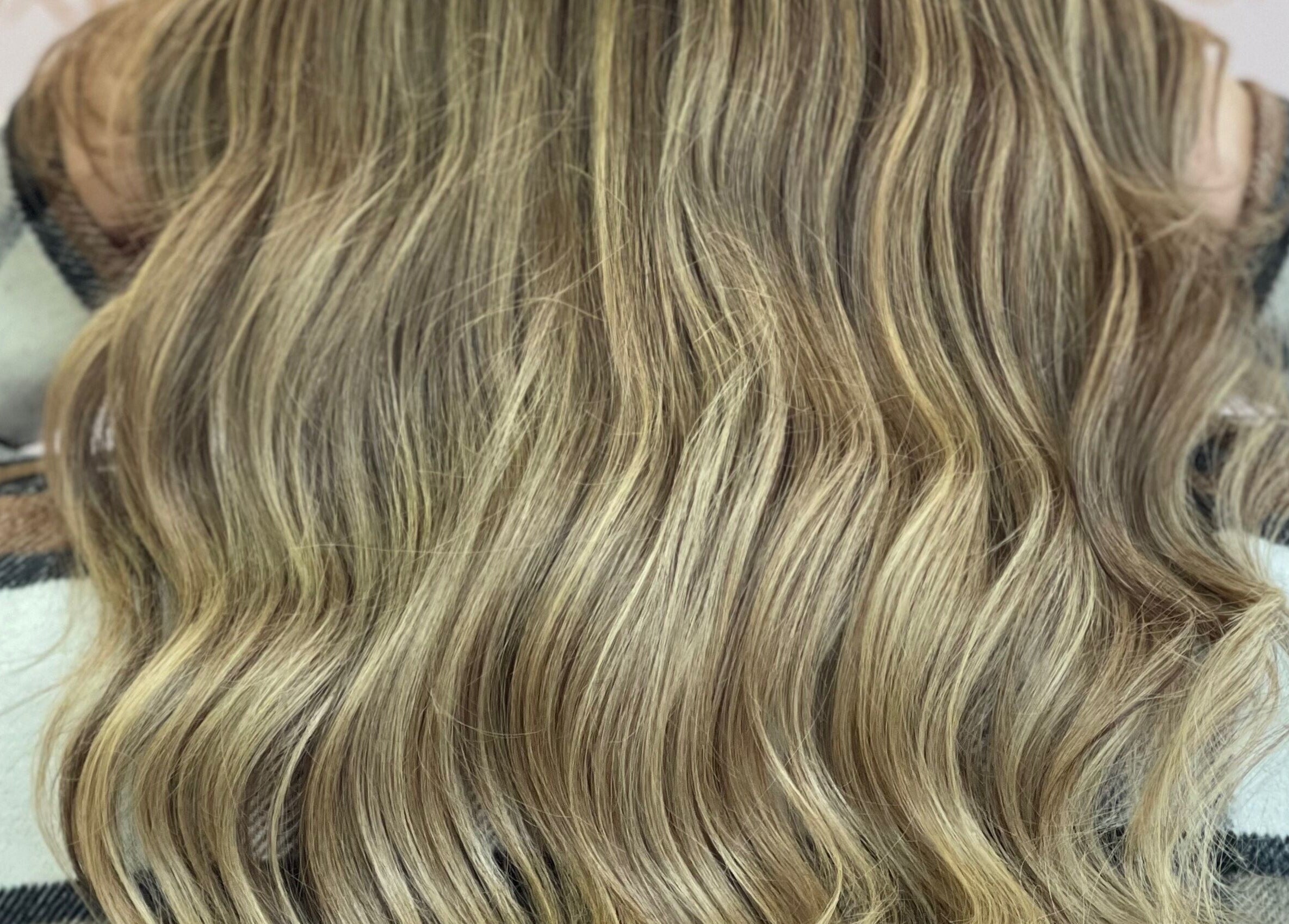 Blonde wavy hair close-up at Moxie at Dreamhair, Shrewsbury, England, GB showcasing natural highlights.