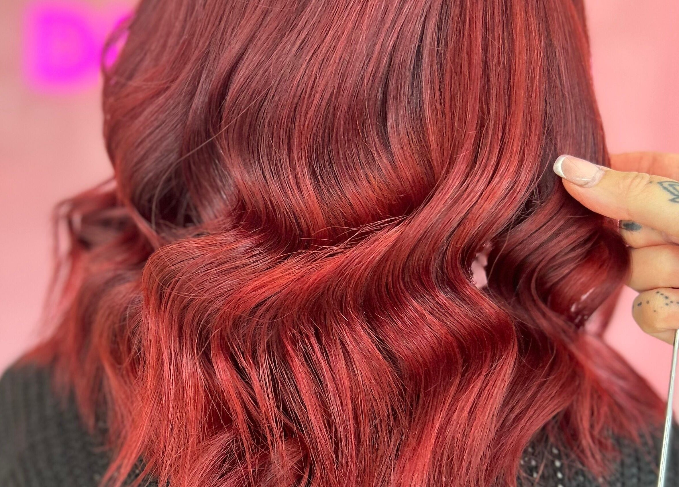 Vibrant red hair styled in waves at Moxie at Dreamhair, Shrewsbury, England, GB.