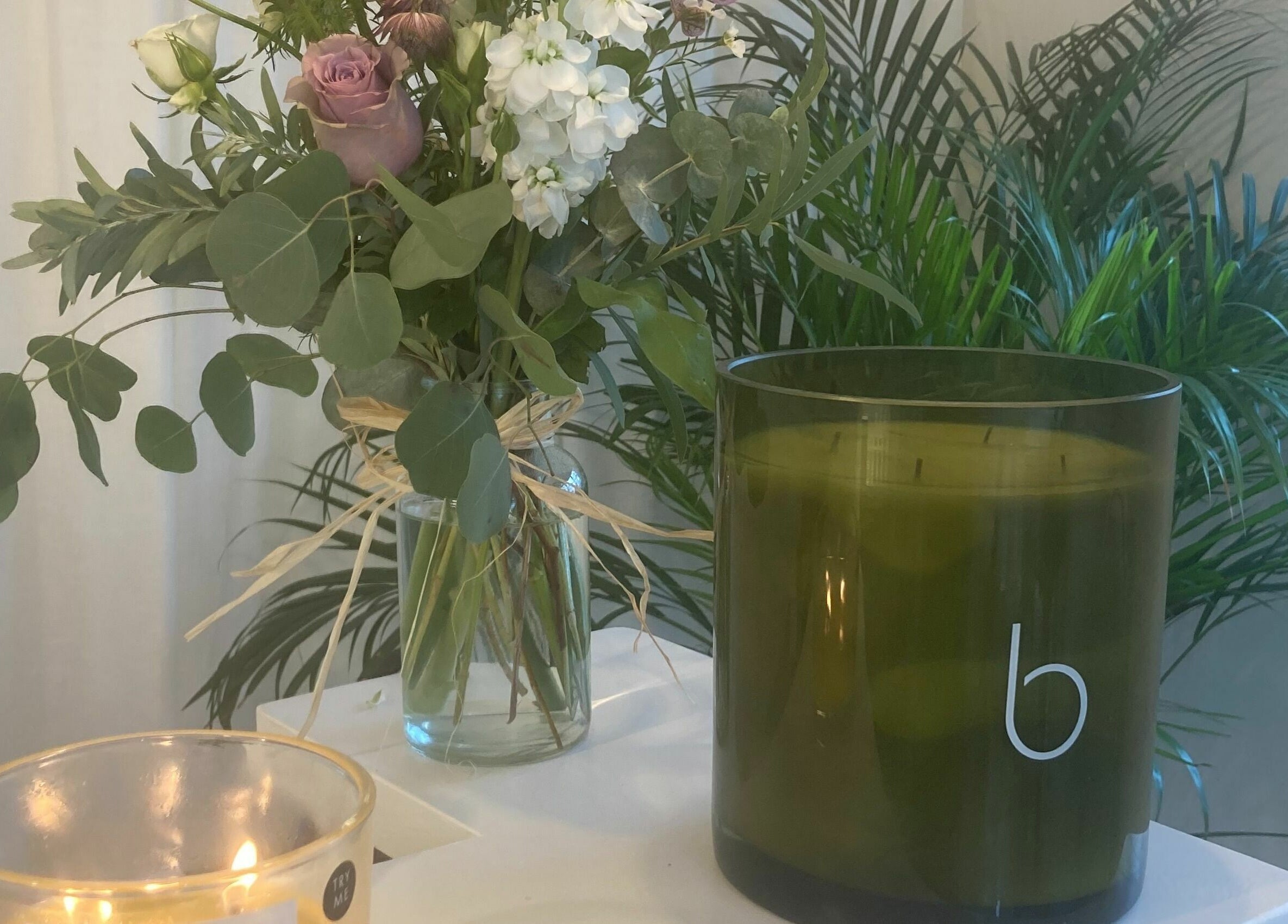 Elegant floral bouquet and candle at The Secret Spa, Holt, Wales, GB create a calming ambiance.