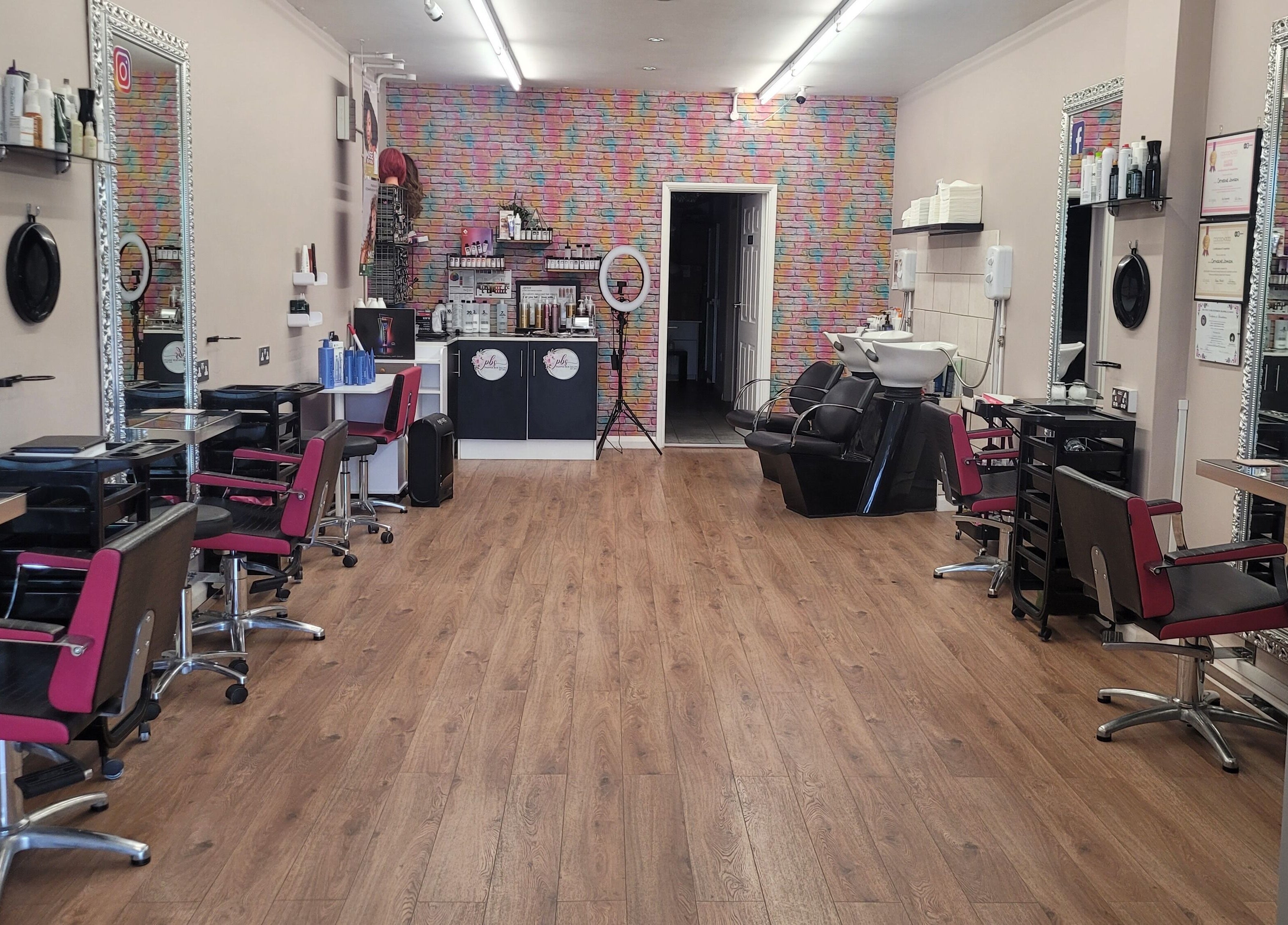 Elegant interior of Pamper Box Salon in Harlow, England, GB featuring styling stations and modern decor.