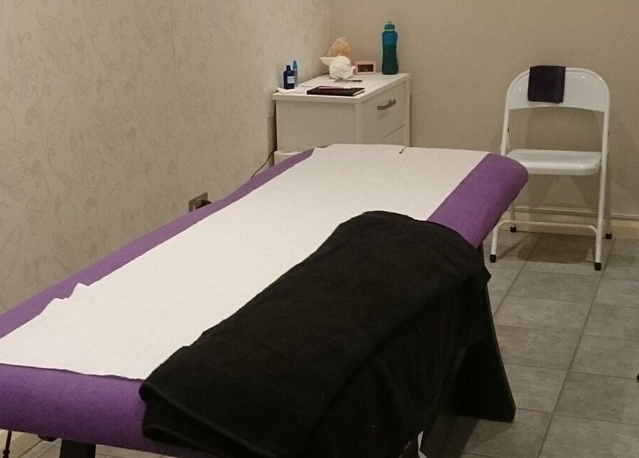 Massage room setup at Pamper Box Salon, Harlow, England, GB with a comfortable table and calming decor.