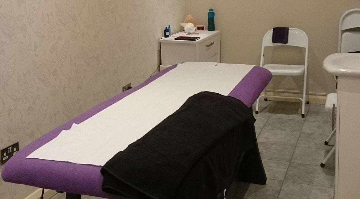 Massage room setup at Pamper Box Salon, Harlow, England, GB with a comfortable table and calming decor.