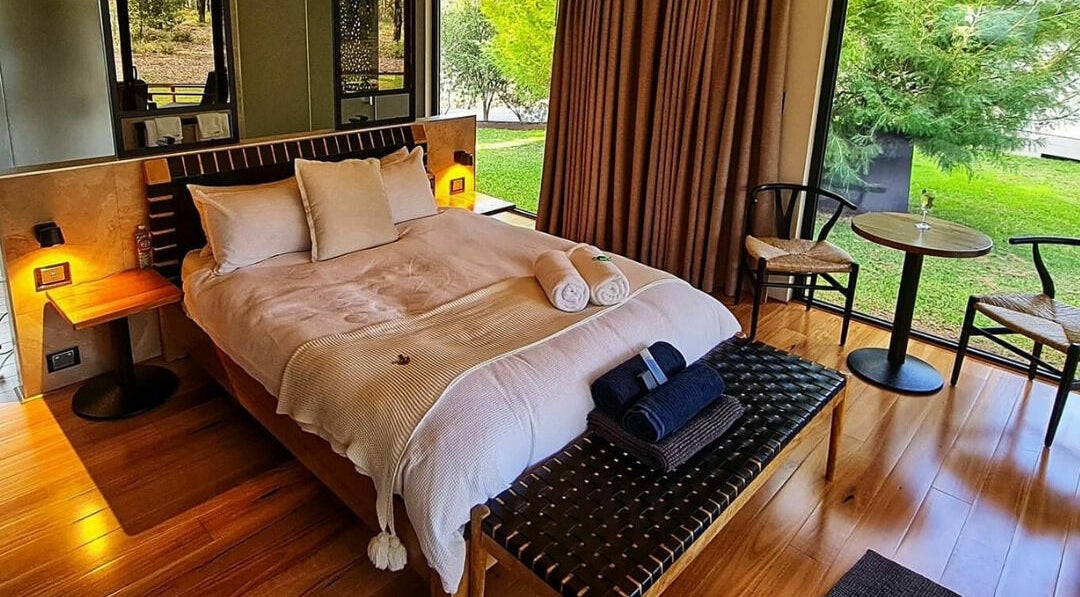 Luxurious bedroom at Amaroo Retreat and Spa, Mount Helena, Western Australia, AU, with scenic garden view.