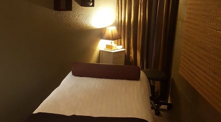 Cozy massage room at Shanna Massage Therapy, Independence, Missouri, US with soft lighting and a massage table.