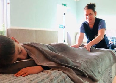 Therapist at Zilda Holistic Therapies in Dunfermline, Scotland, GB, provides a relaxing massage to a client.