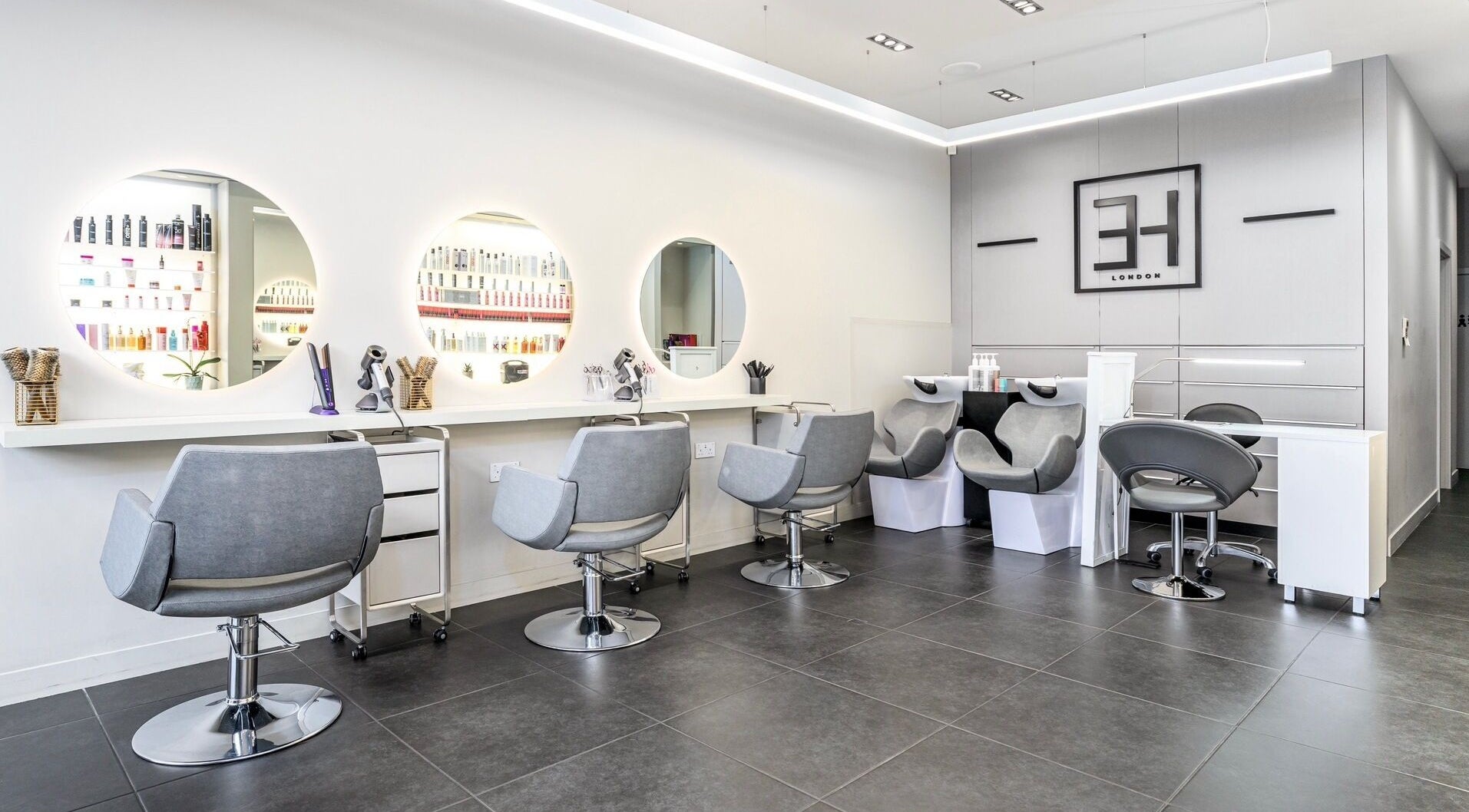 Modern salon chairs and mirrors at Endless Hair & Esthétique in London, England, GB.