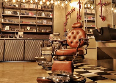 Classic barbershop chairs at Sharqi Gents Salon in Sharjah, AE, offering a luxurious grooming experience.