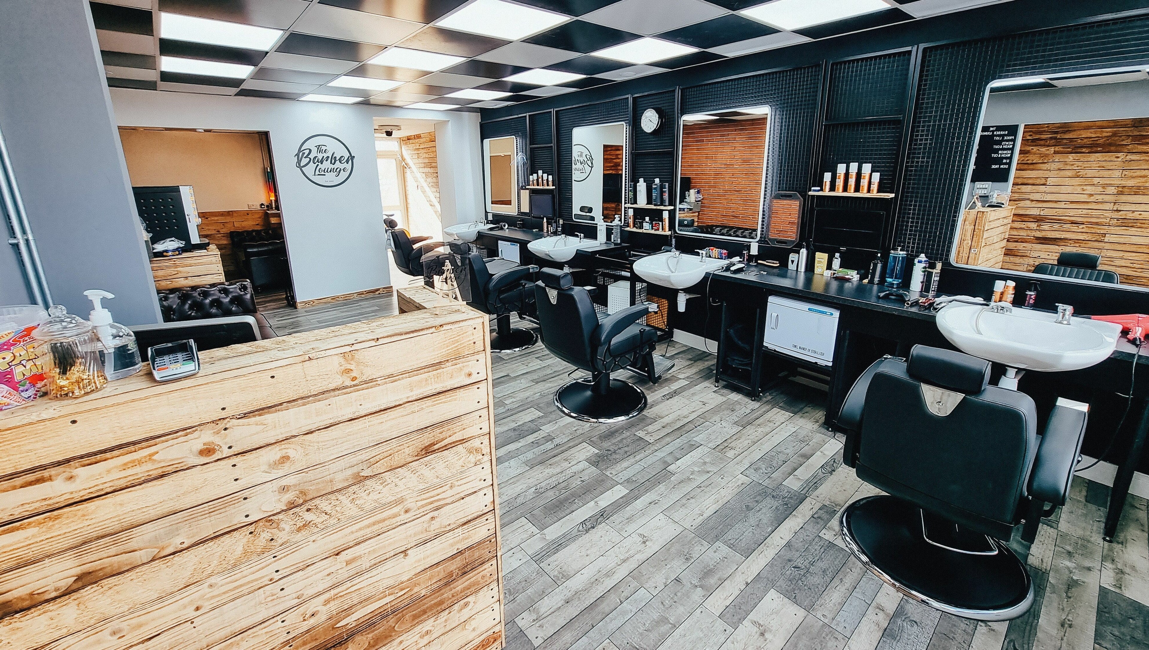 Interior of The Barber Lounge in Talbot Green, Wales, GB showcasing stylish barber chairs and modern decor.