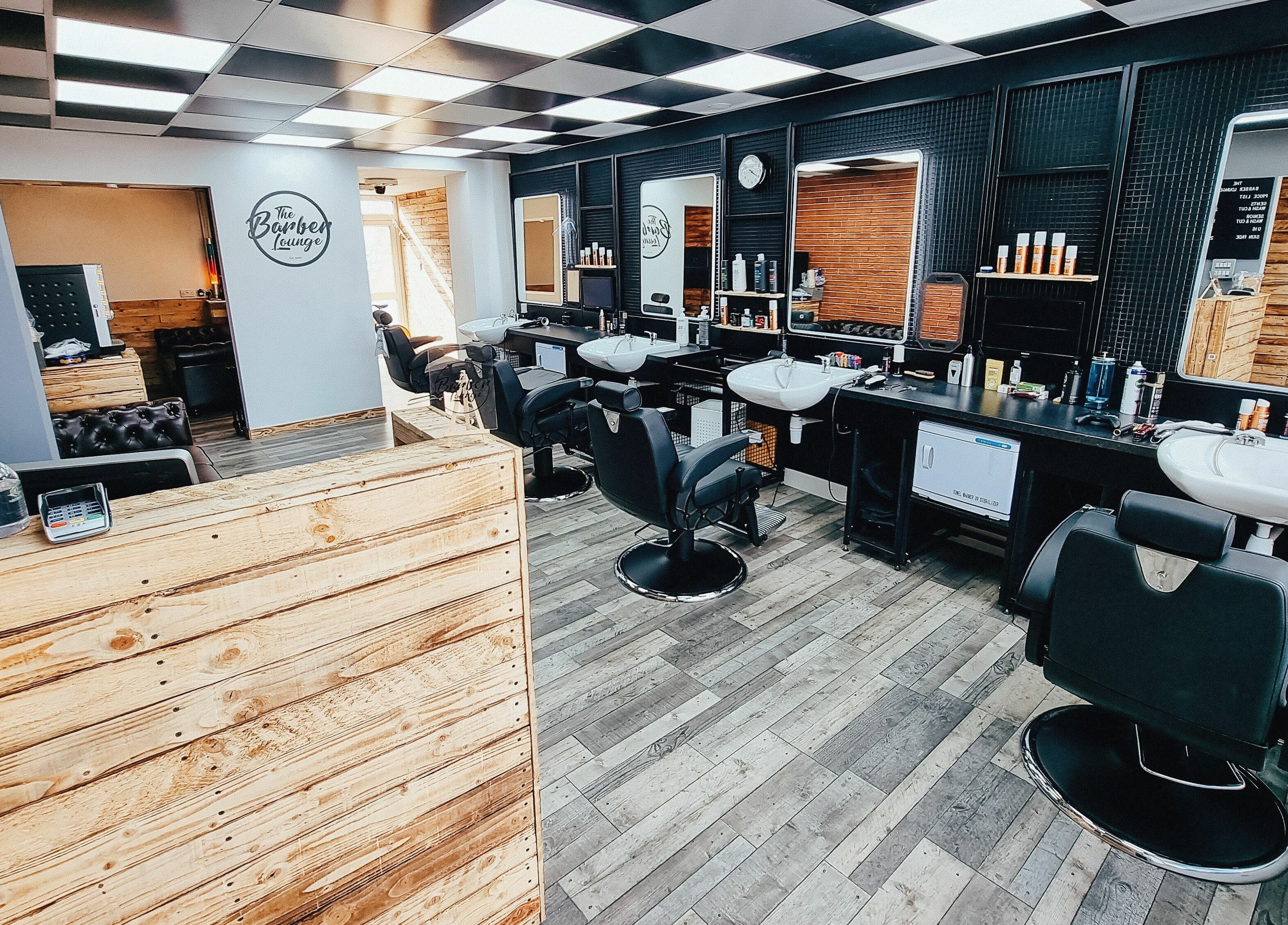 Interior of The Barber Lounge in Talbot Green, Wales, GB showcasing stylish barber chairs and modern decor.