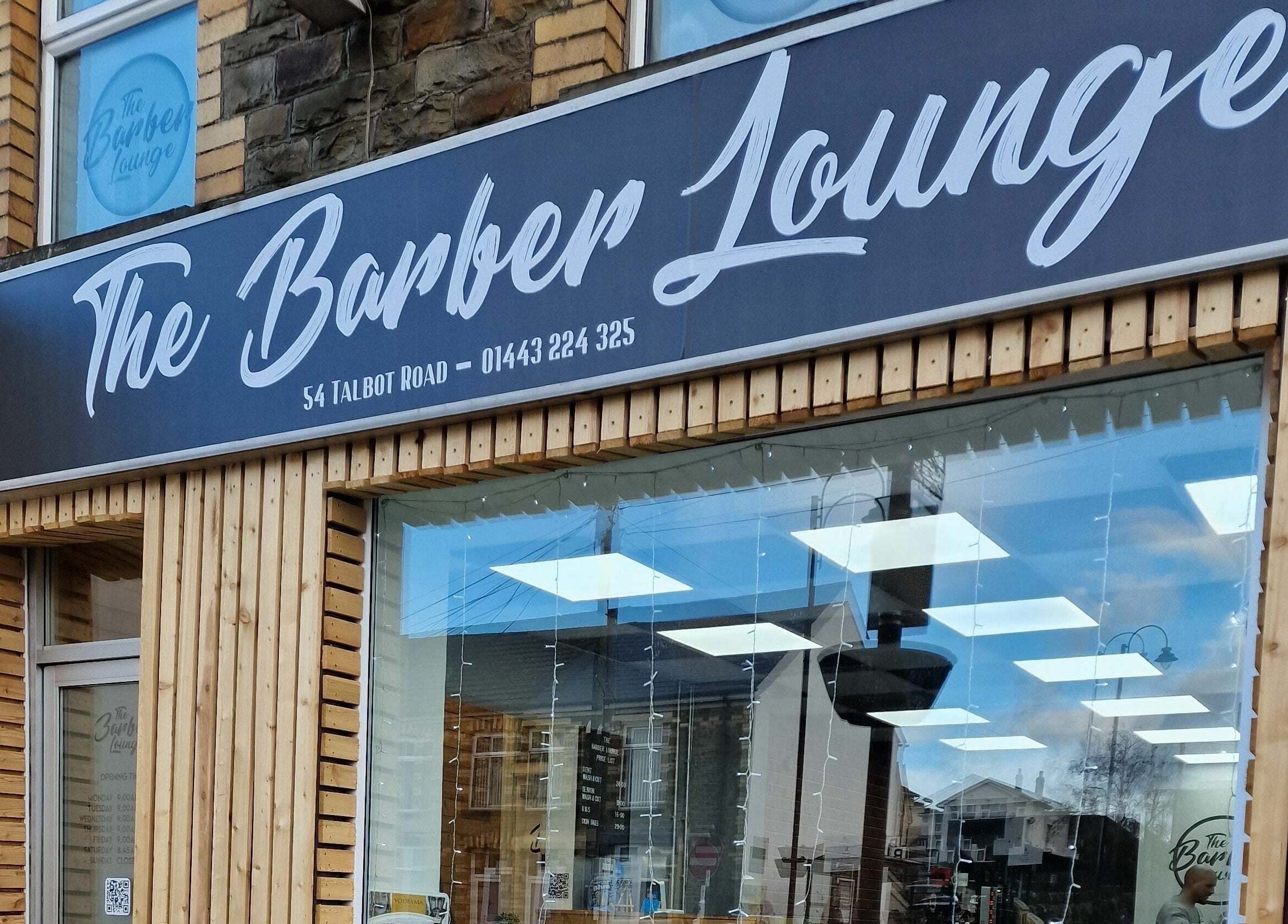 The Barber Lounge shopfront in Talbot Green, Wales, GB, showcasing a modern and inviting exterior design.