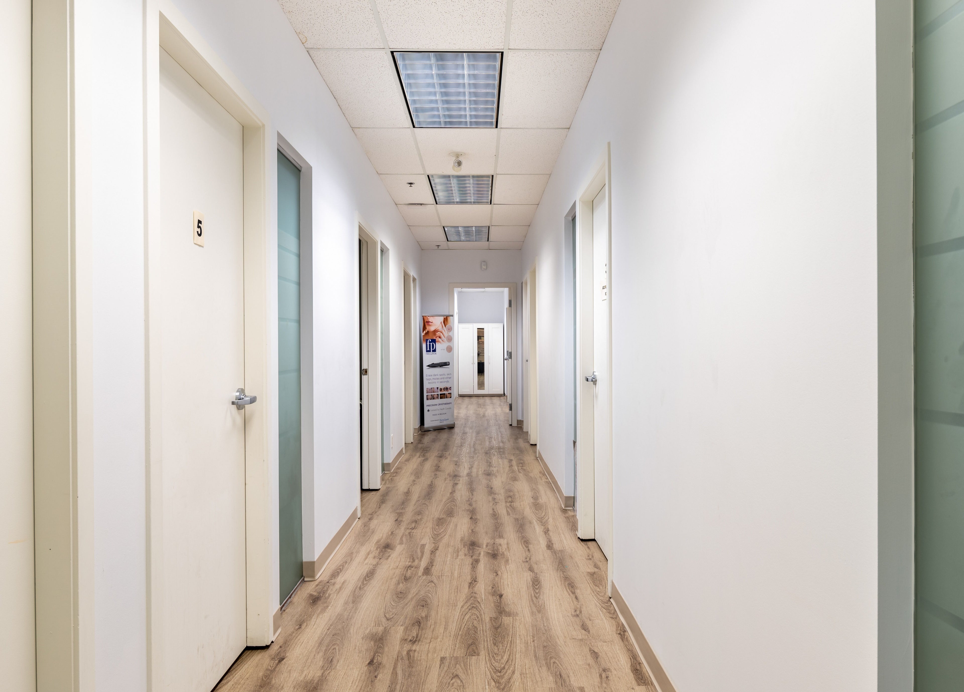 Bright hallway at Nano Beauty in New Westminster, British Columbia, CA showcasing elegant wood flooring.
