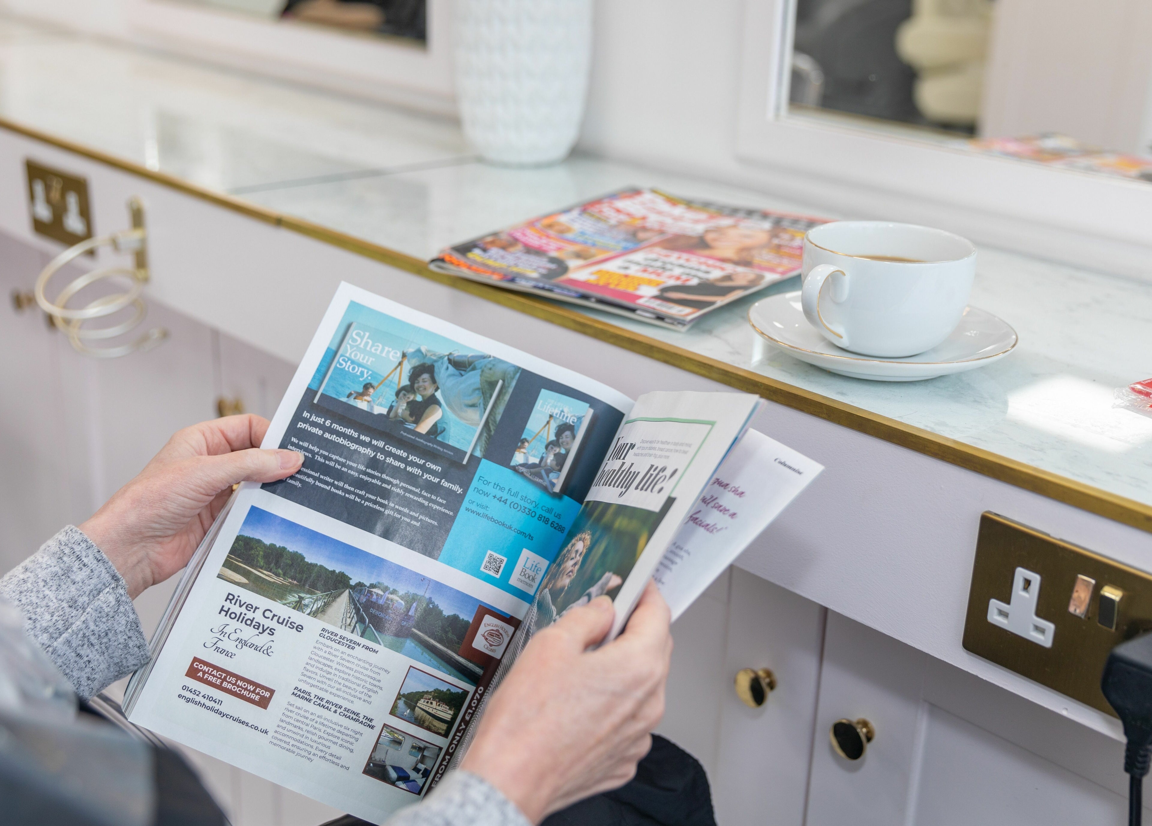 Client enjoys a magazine and coffee at Gemma Scout Hair Studio - Bexleyheath, Bexleyheath, England, GB.