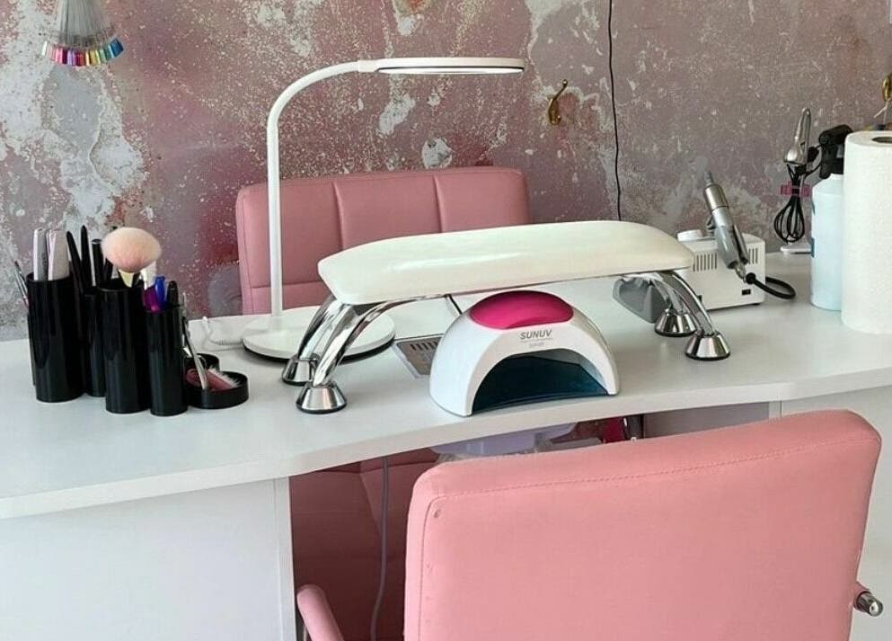 Modern nail station at On Point SE19, London, England, GB. Features pink chairs and manicure tools.
