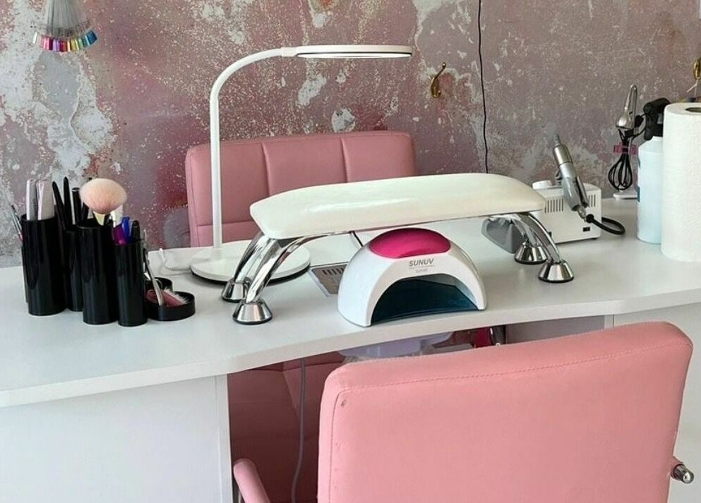 Modern nail station at On Point SE19, London, England, GB. Features pink chairs and manicure tools.