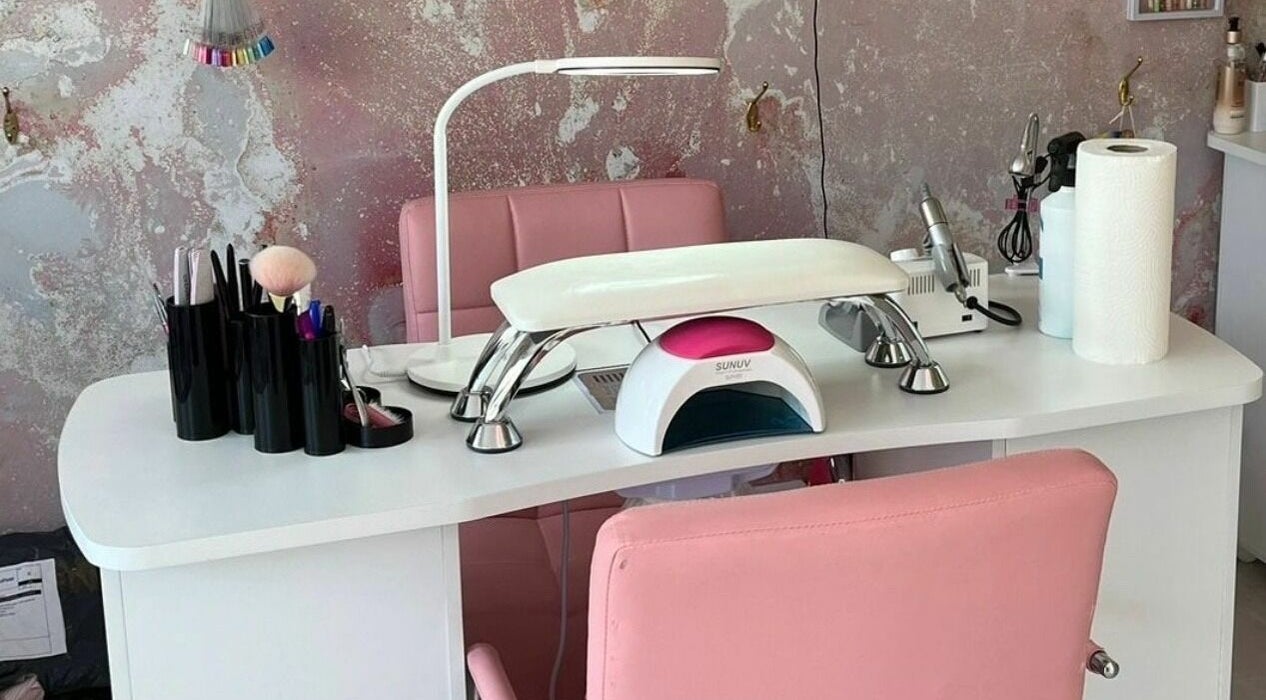 Modern nail station at On Point SE19, London, England, GB. Features pink chairs and manicure tools.