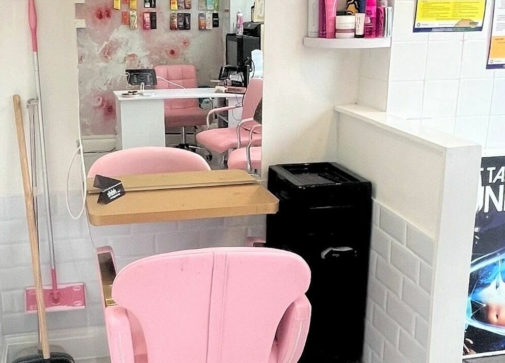 Cozy salon interior with pink chairs at On Point SE19, London, England, GB boasting a modern, inviting design.
