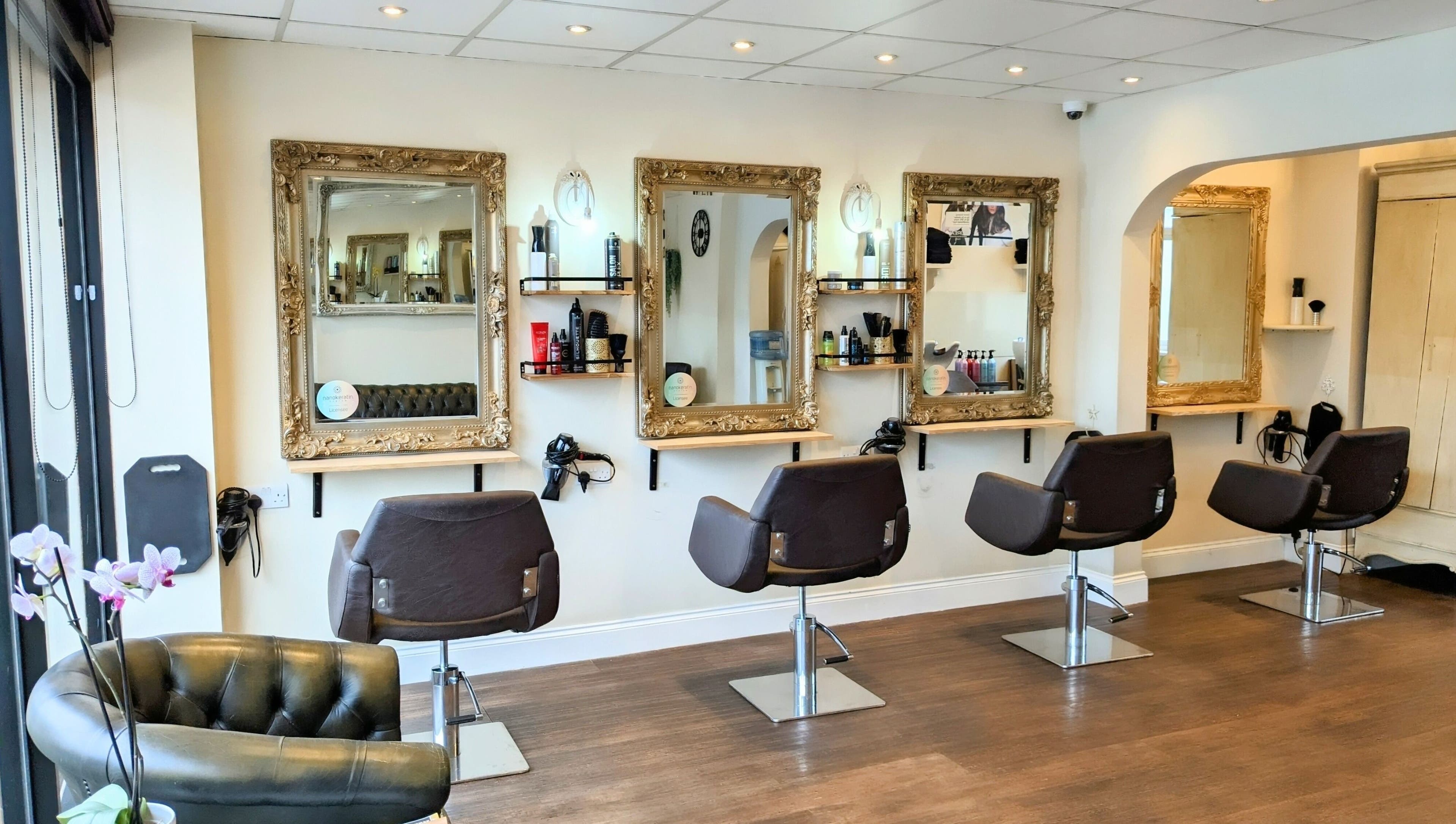 Stylish interior of No.77 Hair Salon Coulsdon with elegant chairs and mirrors in Coulsdon, England, GB.