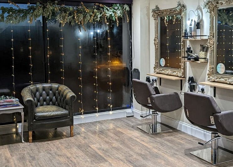 Chic interior of No.77 Hair Salon Coulsdon featuring vintage mirrors and stylish seating in Coulsdon, England, GB.