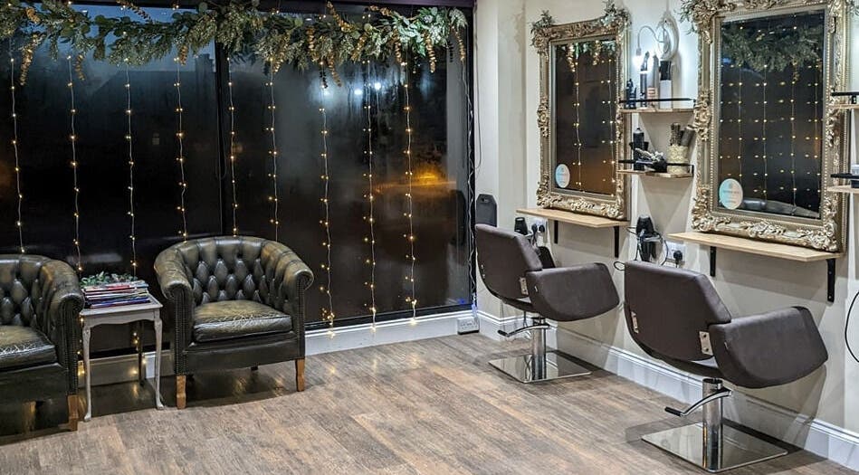 Chic interior of No.77 Hair Salon Coulsdon featuring vintage mirrors and stylish seating in Coulsdon, England, GB.