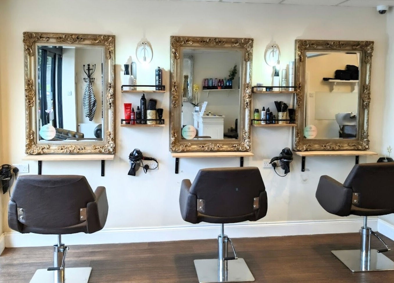 Cozy interior of No.77 Hair Salon Coulsdon with modern chairs and mirrors in Coulsdon, England, GB.