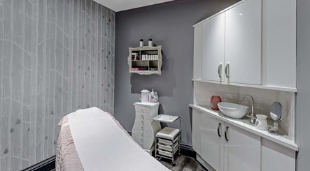 Elegant treatment room at Chewys Collective, Gloucester, England, GB, featuring a cozy massage bed and chic decor.